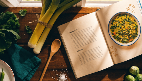 Cozy kitchen flatlay with Easy To Make 5 Star Vegan Recipes cookbook